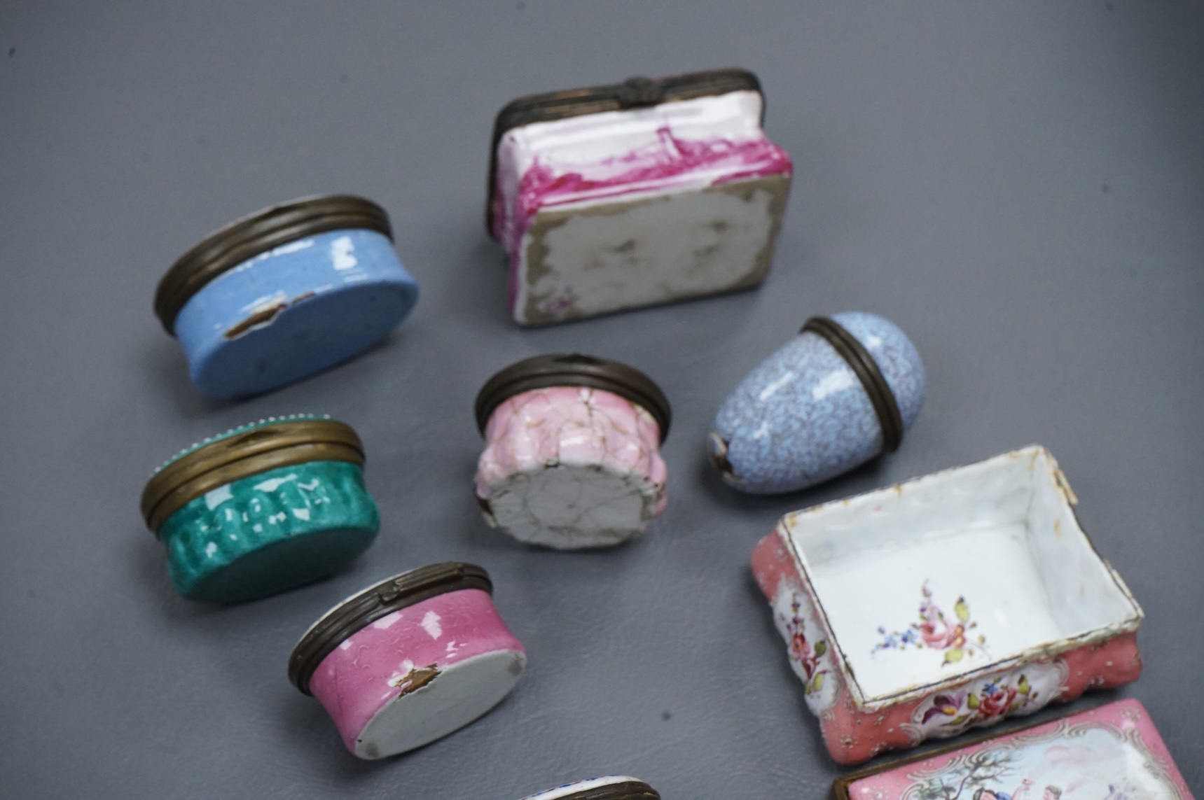 A collection of seven late 18th / early 19th century South Staffordshire enamel patch and snuff boxes and a continental porcelain snuff box, Largest 3.5cm high (8)